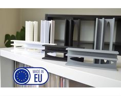 a book shelf with some books on top of it and a european flag sticker next to it