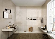 a white bathroom with two sinks and a bathtub next to a window in the room