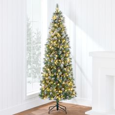 a white christmas tree with lights in a room