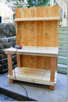 a wooden workbench sitting on the side of some steps with a power cord attached to it