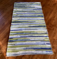 a striped rug on the floor in a room with wood floors and hard wood floors