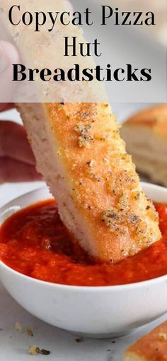 a person dipping some bread into a bowl of red sauce with the words copycat pizza hut breadsticks