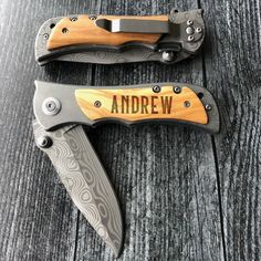 two knives with engraved names on them sitting next to each other