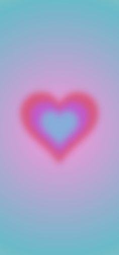 a blurry image of a heart on a blue and pink background