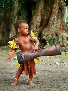 a young boy holding a large piece of metal