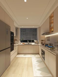 a kitchen with white cabinets and wood flooring next to a window overlooking the city