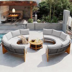 an outdoor living area with couches and tables next to a swimming pool in the background