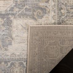 two rugs side by side, one in grey and the other in light gray