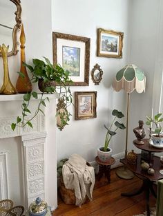 a living room filled with lots of furniture and pictures on the wall above a fire place