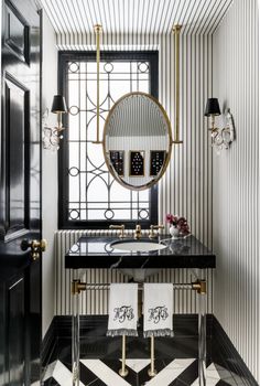 the vanity is by palmer industriess in black and white with gold trimming