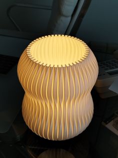 a table with a lamp on top of it next to a computer keyboard and mouse