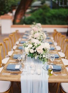 the table is set with blue and white linens