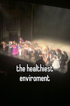 a group of people standing on top of a stage with the words the healthest environment