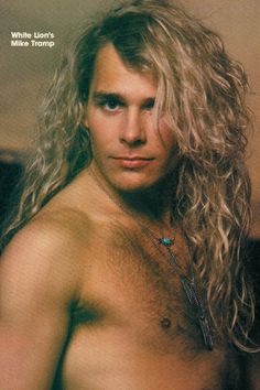 a man with long hair and no shirt on posing for a magazine cover or book