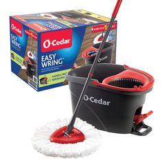 a red and black mop sitting on top of a floor next to a box