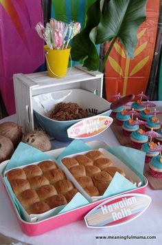 a table topped with lots of cupcakes and muffins on top of plates