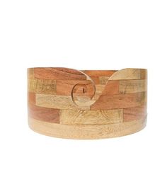 a wooden bracelet with a circle in the middle and two lines on it, all made out of wood