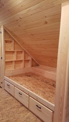 an unfinished bed frame with drawers in the bottom and upper bunk area on the second floor