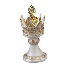 a white and gold crown sitting on top of a table