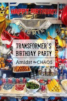 transformer's birthday party with lots of food and decorations on the shelf in front of it