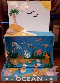 an ocean scene made out of cardboard with sea animals and fish on the bottom shelf