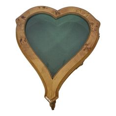 a heart shaped wooden frame with green glass inlays on the front and sides