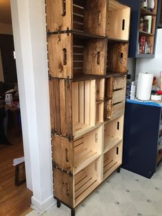 a large wooden shelf with lots of crates on it