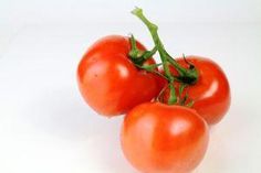 three tomatoes are sitting on top of each other