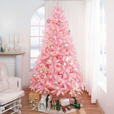 a pink christmas tree in a living room