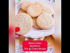 some cookies are on a white plate and there is a red sign that says black folks southern tea cake recipe