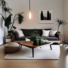 a living room filled with furniture and potted plants on top of a wooden table