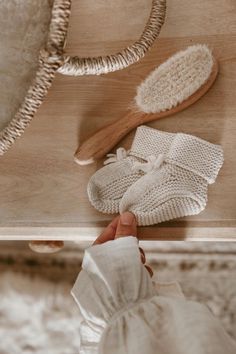 Oat Baby Booties on a dresser next to a hairbrush and basket Names Girl, Baby Knitwear, Best Baby Shower Gifts, Baby Bundles, Luxury Baby, Moss Stitch, Knitted Baby, Baby Outfits, Neutral Baby