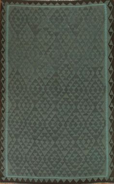 a green and black quilted area rug on the floor