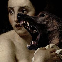 a woman holding a dog with its mouth open