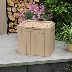 a large wooden box sitting on top of a cement slab next to flowers and trees