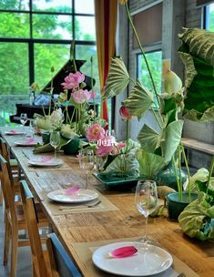 the table is set with flowers and place settings