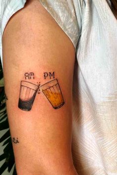 a woman's arm with two glasses of beer on it and the words rm dm