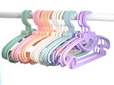 a rack with many different colored hair clips hanging from it