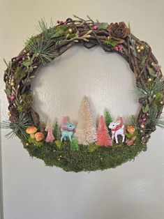 a wreath decorated with fake animals and plants