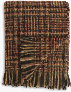 a brown and orange plaid blanket with fringes on it's edges, folded in half