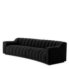 a black couch sitting on top of a white floor