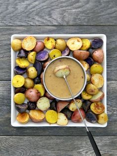 a bowl filled with sauce surrounded by potatoes