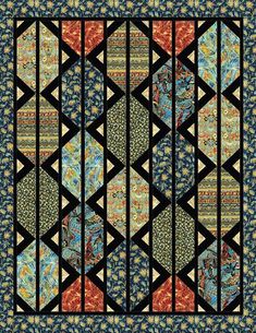 a quilt with an intricate design on it's side and blue, yellow, orange and