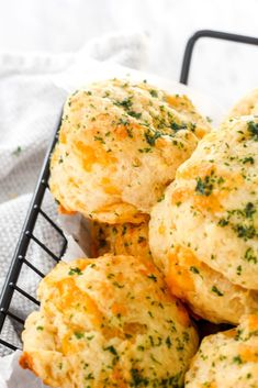 a basket filled with cheesy biscuits on top of a table