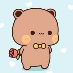 a brown bear with a bow tie holding a flower