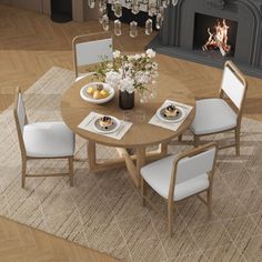 a dining room table with white chairs and a chandelier hanging from the ceiling