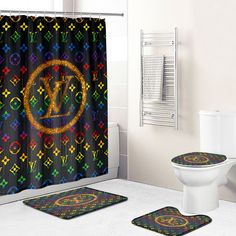 a bathroom with two rugs and a shower curtain in the shape of louis vuitton