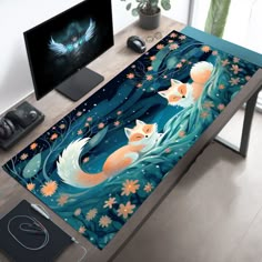 a computer desk with a painting of two foxes on it