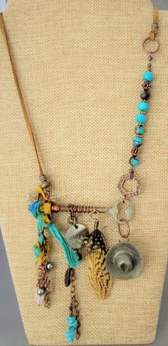 "This is for sure a One Of A Kind necklace. Designed with a genuine skeleton key. Included is vintage Sari silk, ant. copper chain with charms and feathers. A vintage (over 50 years old) cowboy hat (likely made of pewter) that started it's life as a button cover. The necklace has genuine blue semi precious stones (Wagnerite chips and 8mm  reconst. Siderolite with  with copper. Necklace can adjust from a choker length to a  a Princess length, depending on body type. I can easily fit it over my head and adjust from there. Micro-suede gives this a more casual appeal.  The \"Story\" charm represents what everyone has...a story. The vintage pieces add to that. Perhaps the hat and feathers speak to a person who was raised on a farm or horse farm or their family comes from a farm background. It c Chain With Charms, Sari Silk Jewelry, Old Cowboy, Memory Wire Jewelry, Chapeau Cowboy, Key Jewelry, Necklace Antique, Assemblage Jewelry, Vintage Sari