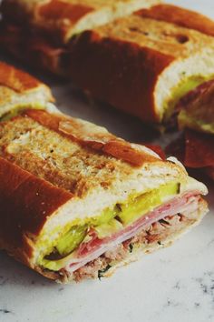 a cut in half sandwich sitting on top of a counter